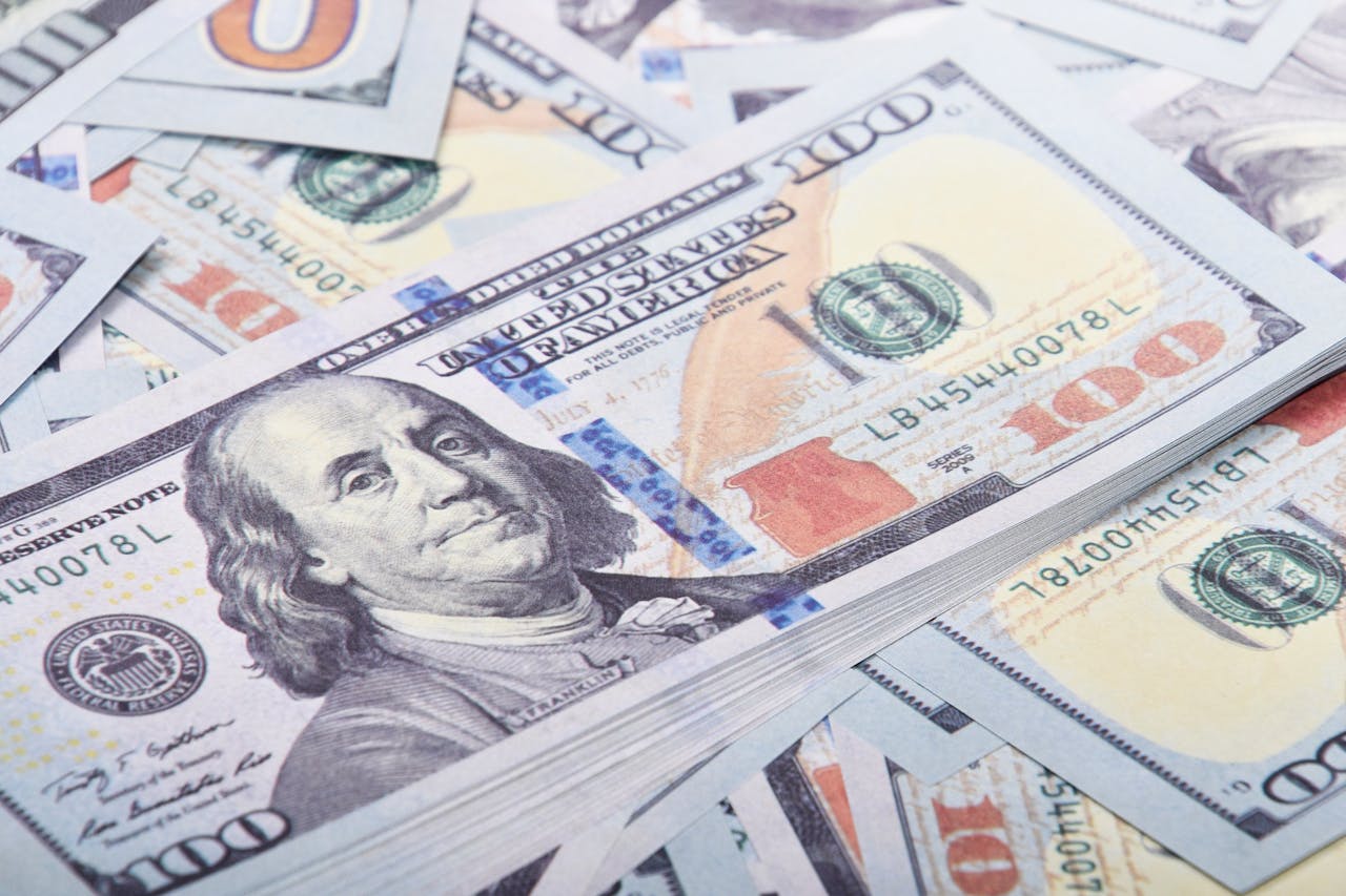 Detailed close-up of United States 100 dollar bills emphasizing currency and finance.